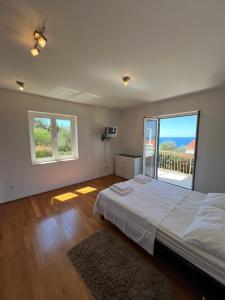 a bedroom with a large bed and a large window at Villa Apartments Mecajac in Cavtat +46 photos