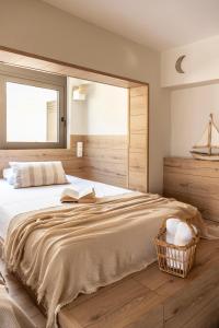 a bedroom with a large bed with a book on it at Casa Meraki by A&D Properties in Porto Rafti +19 photos