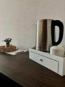 a coffee pot sitting on top of a wooden table at Torre Galli-Dimora di Campagna in Gasponi