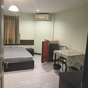 a hospital room with two beds and a table at Fully Furnished Condo Park Lane Resorts 2314 in Jomtien Beach