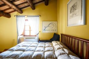 a bedroom with a bed and a window at Locanda Da Ciacci in Petriano