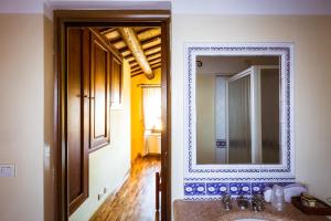 a bathroom with a mirror and a sink at Locanda Da Ciacci in Petriano +24 photos