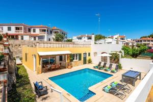 a villa with a swimming pool and a house at Villa Las Mariposas by Villa Plus in Es Mercadal