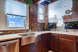 a kitchen with a sink and a brick wall at Inviting 3-Lvl DC Townhome Walk to METRO Station & Union Market H Street NoMa Union Station in Washington, D.C. +20 photos