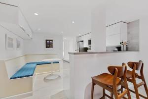 a kitchen with white cabinets and a table and chairs at Heart Of Dupont and Walk to Georgetown in Washington, D.C.