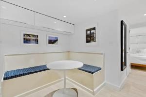 a white room with a table and a bed at Heart Of Dupont and Walk to Georgetown in Washington, D.C.