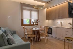 a kitchen and living room with a table and a couch at Avli in Preveza