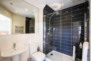 a bathroom with a toilet and a sink and a shower at Northern Hideaways Seascape, Seahouses in Seahouses
