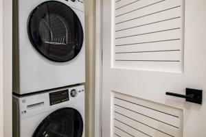 two washer and dryers in a laundry room at Eastern Market & METRO Accessible Modern Charm Walk Everywhere in Washington, D.C.