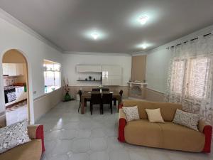 a living room with a couch and a dining room at Villa Grazia in Petrosino +19 photos