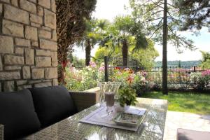 a glass vase sitting on a table on a patio at Calma bungalows in Portorož