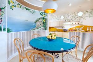 a kitchen with a blue table and chairs at Estate4home - Casa Nonna Mary in Positano
