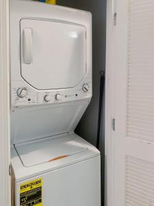 a white refrigerator with a tv on top of it at Central DC Flat Sleeps 3 Convention Center in Washington, D.C.