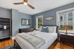 a bedroom with a large bed and blue walls at Historic & Modern Capitol Hill 2-BR Row Home in Washington, D.C.