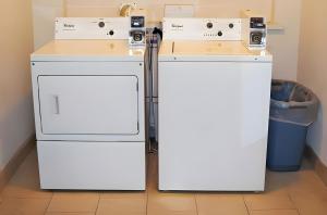two refrigerators are sitting next to each other in a room at Scottish Inns - Middletown in Middletown