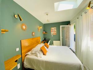 a bedroom with a large bed with green walls at Hotel Saint-Michel in Dinard