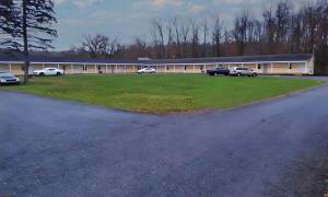 a large building with cars parked in front of it at Scottish Inns - Middletown in Middletown