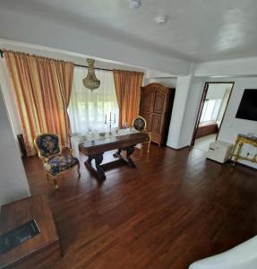 a living room with a table and two chairs at CRAMA APOGEUM - Adult only in Gura Vadului