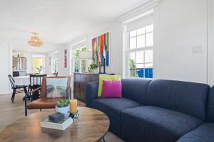 a living room with a blue couch and a table at The Summerhouse @ Saint Peters in Saint Peters