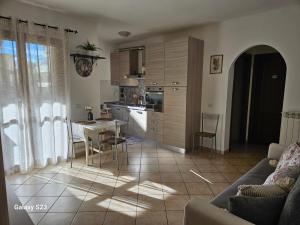 a kitchen and living room with a table and chairs at Mary House in Ladispoli