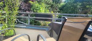 a chair sitting on a balcony with a view at Schöne gemütliche Wohnung in Meerbusch