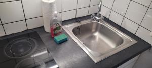 a stainless steel sink in a small kitchen at Schöne gemütliche Wohnung in Meerbusch