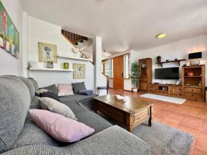 a living room with a couch and a table at Casa Playa Abades in Abades +37 photos