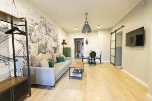 a living room with a couch and a wall at Apartamenty Rynek 12 in Tarnów