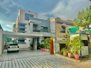 a car parked in front of a house at Millat Guest House F10-4 in Islamabad