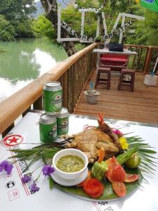 a table with a plate of food on a table at Cool Pool Bungalow in Ban Phônmuang