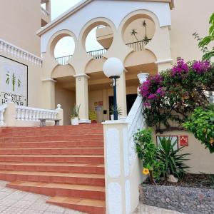 a building with stairs and flowers in front of it at Studio Los Cristianos Atlantic View in Los Cristianos
