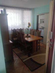 a dining room with a table and some chairs at Petronas Apartment in Niš +6 photos
