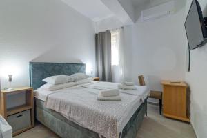 a bedroom with a bed with two towels on it at Vila DADA 2 in Senj