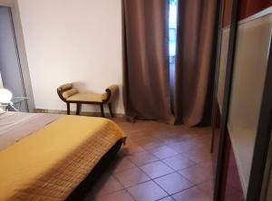 a bedroom with a bed and a chair and a window at Apartment Stella Casa Bruno in Vrsi