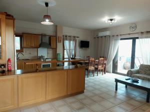 a kitchen and living room with a couch and a table at The view in Alika in Álika