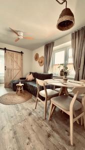 a living room with a table and a couch at Morze To Tu in Mielno