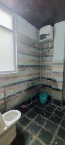 a bathroom with a toilet and a sink at La Vilasa in Jibhi +22 photos