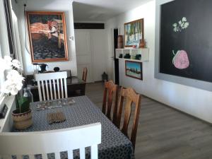a dining room with a table and chairs and a chalkboard at Summer Home in Muuruvesi