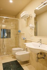 a bathroom with a sink and a toilet and a shower at Hotel Art Atelier in Florence
