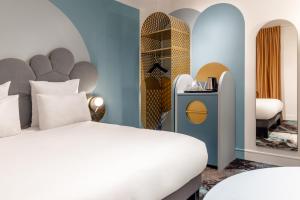 a bedroom with a bed and a room with archways at Mercure Annecy Centre in Annecy +58 photos