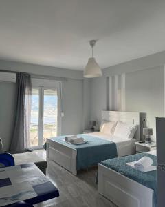 Postel nebo postele na pokoji v ubytování Filikouri Rooms