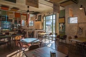 a restaurant with tables and chairs in a room at Un posto a Milano - guesthouse all'interno di una cascina del 700 in Milan