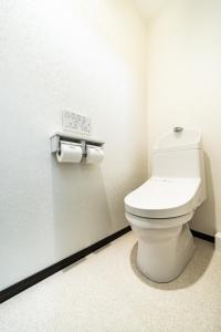 a bathroom with a toilet and two rolls of toilet paper at 84-5, Shiomi 301, Entire room for rent in Tokyo