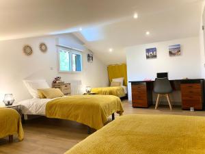 a bedroom with two beds and a desk at Villa Pins&Spa Piscine Jacuzzi Petanque Ping-pong in Andernos-les-Bains +24 photos