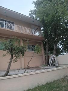 a house with a ladder on the side of it at Abbasi guest house in Murree