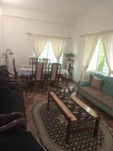 a living room with a couch and a table at Abbasi guest house in Murree