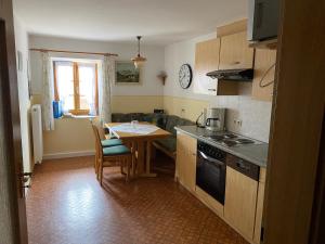 a kitchen with a table and a dining room at Kalbhof in Breitbrunn am Chiemsee