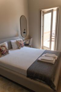 a bedroom with a bed with towels on it at dvnest - Premium 1BR Apartment with River View! in Porto