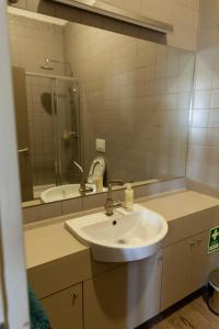 a bathroom with a sink and a mirror at dvnest - Premium 1BR Apartment with River View! in Porto