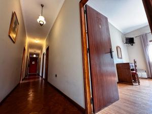 an empty hallway with a wooden door in a room at AL Nonna Eli (Alojamento Local) in Campos +31 photos